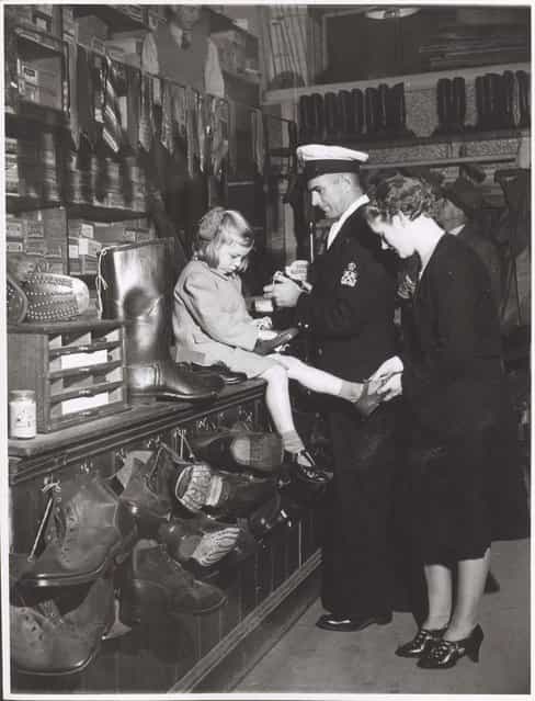 Woman and child buying shoes in the shoe section of Bell and Macaulays Store, Drouin, Victoria, ca. 1944