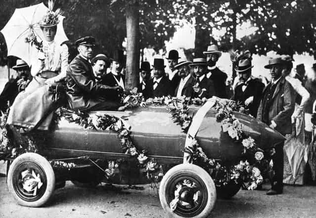Laurels for Camille Jenatzy (in driver's seat), the first man to exceed 100 kph (62 mph) at Acheres, near Paris. The car, christened [Jamais Contente], was an electric vehicle of his own design, 1899.