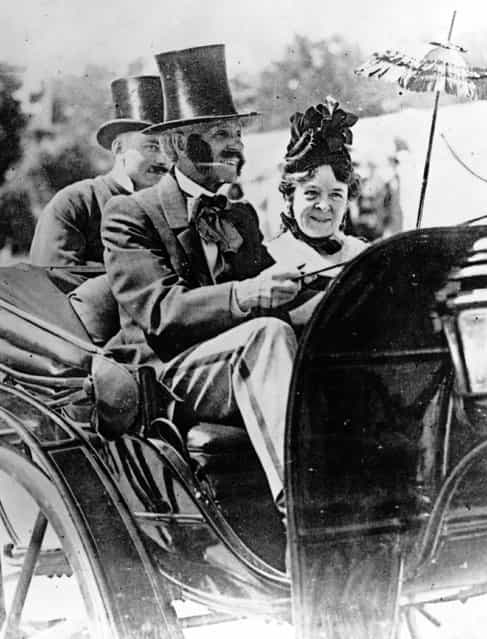American inventor, industrialist and motor car pioneer Henry Ford (1863–1947) driving an 1860 Pageant motor car whilst his wife Clara sits beside him.