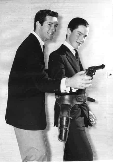 Etonian Lord Rollo Fielding, son of the Earl of Denbigh, wears a holster during pistol practice with TV star Hugh O'Brien, who stars in the hit series [Wyatt Earp]. 21st January 1959. (Photo by Keystone)