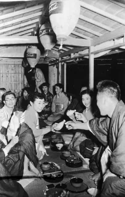 Japanese Geishas wearing Kimonos serve tea in a lounge on board a boat sailing on the Nagara River, circa 1950. (Photo by Three Lions)