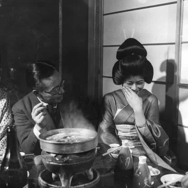 A geisha girl laughing shyly and politely at a joke, circa 1955. (Photo by Three Lions)
