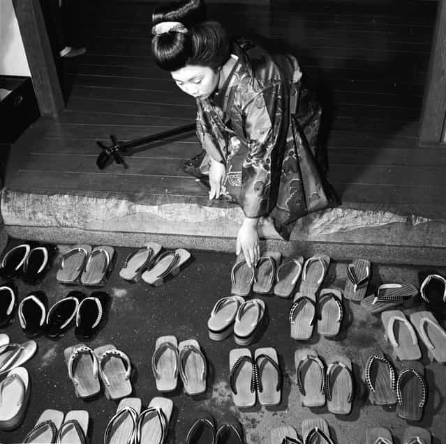 A geisha girl arranges her selection of footwear, circa 1955. (Photo by Orlando/Three Lions)