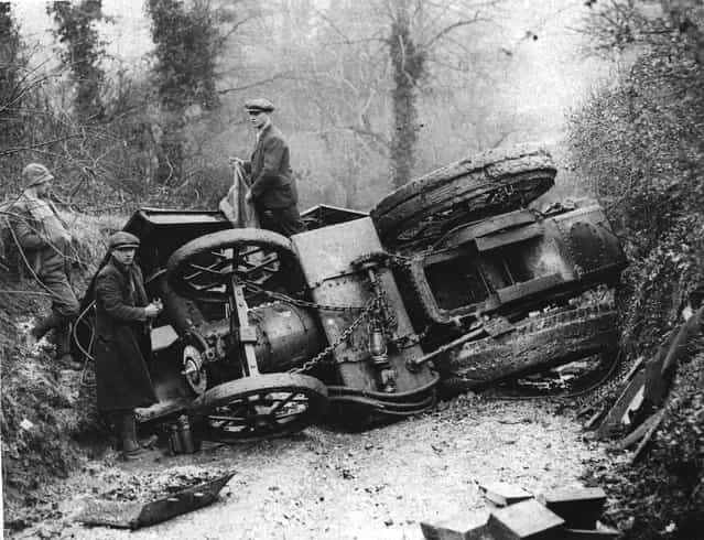 A group of men around an overturned traction engine in a lane in Winford, Somerset. 26th March 1936. (Photo by Fox Photos)