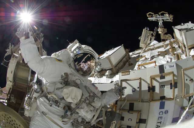 Above the Earth, NASA astronaut Sunita Williams, Expedition 32 flight engineer, appears to touch the bright sun during the mission's third session of extravehicular activity (EVA) on September 5, 2012. During the six-hour, 28-minute spacewalk, Williams and Japan Aerospace Exploration Agency astronaut Aki Hoshide (visible in the reflections of Williams' helmet visor), flight engineer, completed the installation of a Main Bus Switching Unit (MBSU) that was hampered by a possible misalignment and damaged threads where a bolt must be placed. They also installed a camera on the International Space Station's robotic arm, Canadarm2. (Photo by NASA)