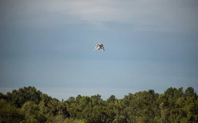 The [Mighty Eagle] soars above the tree line on August 16, 2012. The vehicle was [open loop] – navigating autonomously without the command of the onboard camera and flying on a preprogrammed flight profile. This NASA robotic prototype lander sailed to an altitude of 100 feet during another successful free flight August 28 at NASA's Marshall Space Flight Center in Huntsville, Alabama. The test is part of a new series of free flights testing the robotic prototype lander's autonomous rendezvous and capture capabilities. (Photo by NASA/MSFC/Fred Deaton)