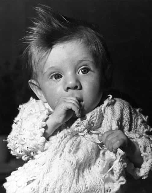 A thumb-sucking baby, circa 1935. (Photo by Fox Photos)