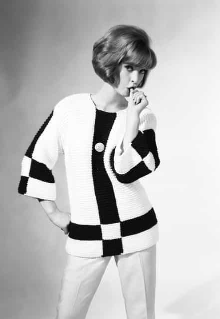 Sucks. A woman wearing a jumper in contrasting colours sucks her thumb suggestively. 27th July 1962. (Photo by Chaloner Woods)