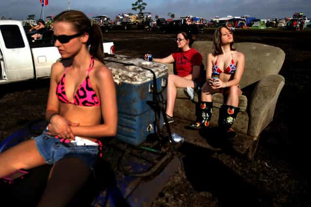 Megan McDaniel of New Smyrna Beach, Nikki Skaggs of Leachville, Arkansas, and Chelsea Johnson of Edgewater, Arkansas, take in the sights from a couch pulled by an ATV. (Photo by Gary Coronado/The Palm Beach Post)
