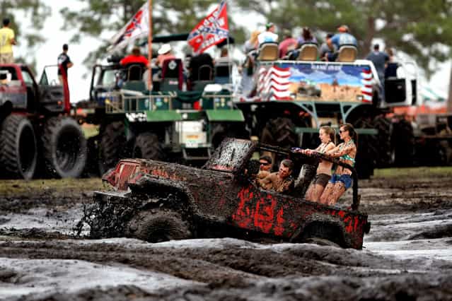 A jeep gets stuck in the mud bog. Getting stuck is usually not a problem: There are plenty of owners with larger trucks willing to pull out stranded vehicles. (Photo by Gary Coronado/The Palm Beach Post)