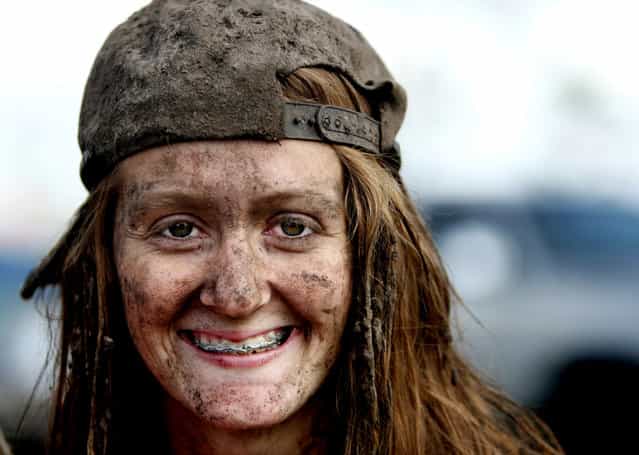 The mud covering her hat, hair and face can't cover the smile of Casey Walls, 17, of Port St. Lucie. (Photo by Gary Coronado/The Palm Beach Post)
