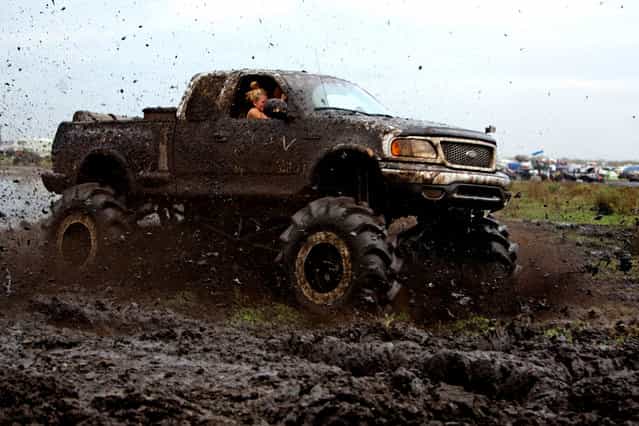 A truck races through the mud bog. (Photo by Gary Coronado/The Palm Beach Post)