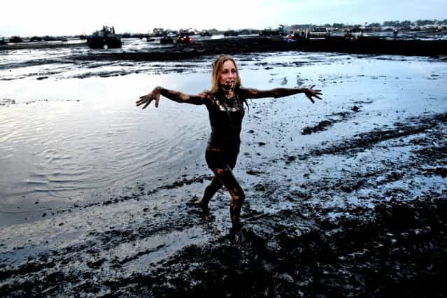 Danielle Piazza of New Smyrna Beach walks out of the mud bug. (Photo by Gary Coronado/The Palm Beach Post)
