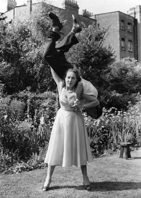 Stuntwoman Connie Tilton, tough girl of British films, swings a man round on her shoulders. 18th August 1953. (Photo by Keystone)