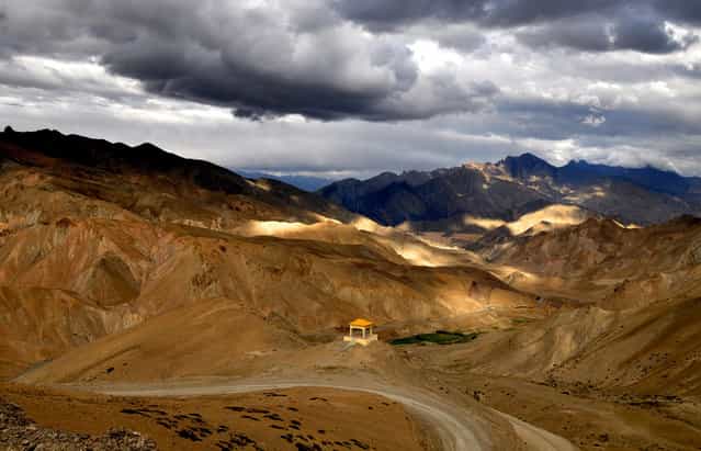 Shades: This view of the Ladakh range near Lamayuru, Ladakh, Jammu and Kashmir, was encountered on my way to Leh. The colors of these ranges keep on changing as the day progresses. The blue shades of the mountains enveloped by clouds afar added to the natural contrast with the golden hue of sun in front. (Photo by Ankur Sharma/National Geographic Photo Contest