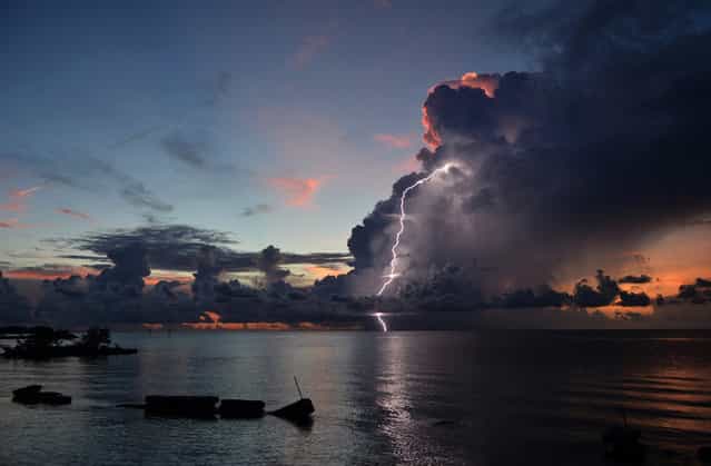 Lightning Sunset: Thunderstorms in the Florida Keys are often sporadic, short-lived, and incredibly isolated. This photo shows a small cluster of storm clouds that had blown in during a sunset on an otherwise clear day. (Photo by Judy Jinn/National Geographic Photo Contest