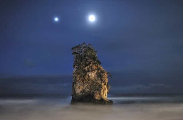 With a Couple of Jovian and Lunar Lights: Jupiter and the Moon light up the sky above a rock formation near Kitaibaraki City, Japan. (Photo by Dr. Akira Takaue/National Geographic Photo Contest