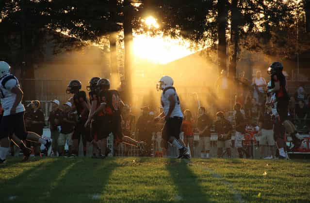 California Football: [As the sun sets on the Eagles home field at the California School for the Deaf in Freemont, the Richmond High Oilers try to overcome a 31 point deficit in the first half. The Oilers held a state high losing streak at 39 losses in 2005. In 2012 season, they have yet to win a game. If the past is any preview of the future, chances dwindle that they will win as the season continues. Due to academic struggles, asthma and other issues that haunt the city of Richmond, many players do not see the season to its completion]. (Photo by Lauren Kate Rosenblum/National Geographic Photo Contest