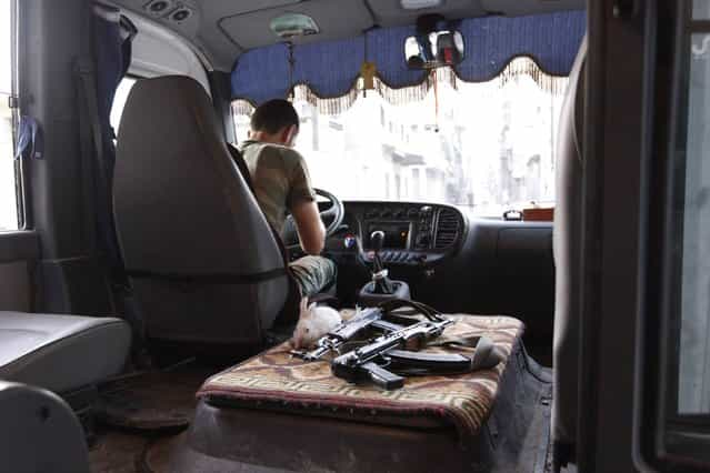 A rabbit is pictured next to weapons in a Free Syrian Army bus in Bustan Al-Basha district in Aleppo September 18, 2012. (Photo by Zain Karam/Reuters)