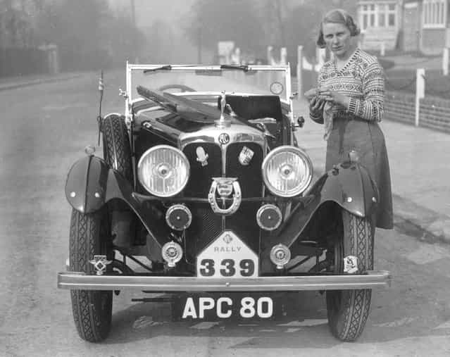 British Rally driver, Kitty Brunell polishing her AC sports car after winning a Hastings RAC rally in it, circa 1935. (Photo by General Photographic Agency)