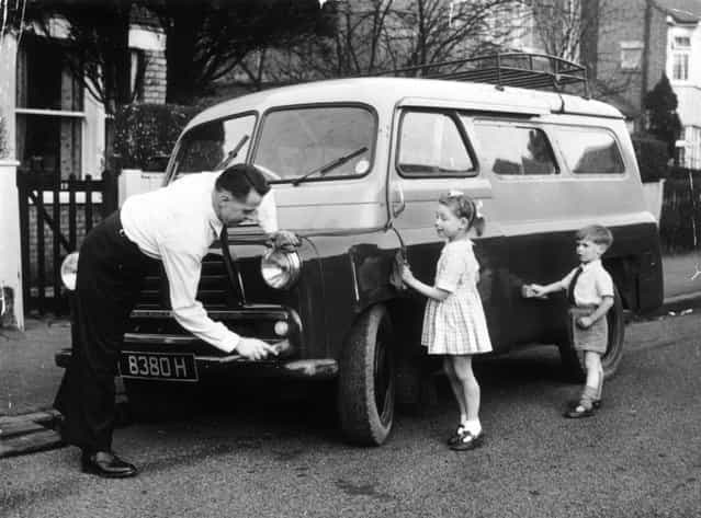 1968, Outside his home, Dennis Uttley polishes the van he bought in order to take groups of deaf children on outings. Helping him are his own two children, Andrew and Jean. (Photo by John Drysdale/Keystone)