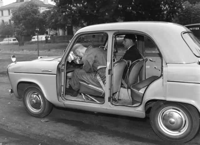 A demonstration of the efficacy of seatbelts in preventing injuries, at the Gloucester Slips in Regent's Park, London, 18th May 1960. An emergency brake causes a dummy passenger with no sash seatbelt to hurtle forward and crack his head on the dashboard. (Photo by William Vanderson/Fox Photos/Hulton Archive)