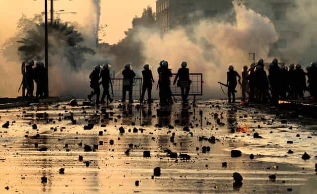 Police fire tear gas as they chase anti-government protesters throwing stones and petrol bombs on the outskirts of the capital of Manama, Bahrain, Oktober 2, 2012. (Photo by Hasan Jamali/Associated Press)