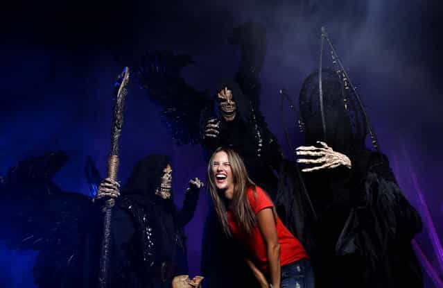 Victoria's Secret model Alessandra Ambrosio poses with members of The Iniquitus, patrons of death, during a sneak peek at Universal Orlando's Halloween Horror Nights 22, on September 26, 2012. (Photo by Kevin Kolczynski/Universal)