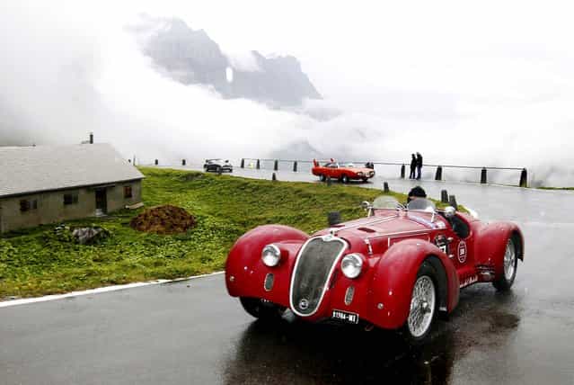 Vintage cars attend the prologue of the traditional [Klausenrennen] car race at the Klausenpass between Glarus and Altdorf, Switzerland, on September 29, 2012. (Photo by Urs Flueeler/Keystone)