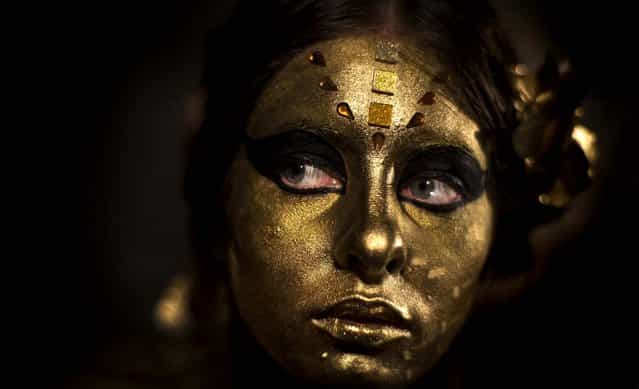 A model shows her body paintings drawn during the night of body art in Moscow, on September 30, 2012. (Photo by Alexander Zemlianichenko/Associated Press)