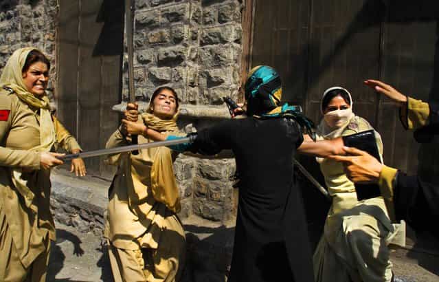 Kashmiri paramedic students scuffle with Indian police women during a protest in Srinagar, India, on September 26, 2012. Police used batons to disperse hundreds of paramedic students protested their recent exam in which 90 percent students were failed. (Photo by Mukhtar Khan/Associated Press)