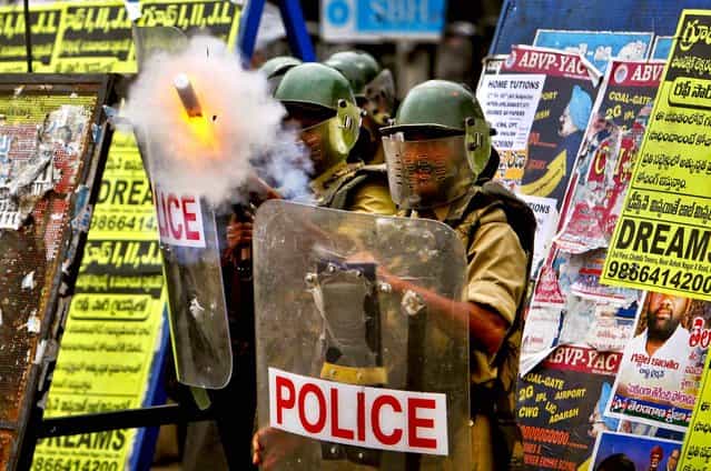 Police fire tear gas at students to prevent them from marching towards the Andhra Pradesh state legislative assembly at Osmania University in Hyderabad, India, on September 17, 2012. The students demanded that a new state of Telangana be carved from the existing Andhra Pradesh state. (Photo by Mahesh A. Kumar/Associated Press)