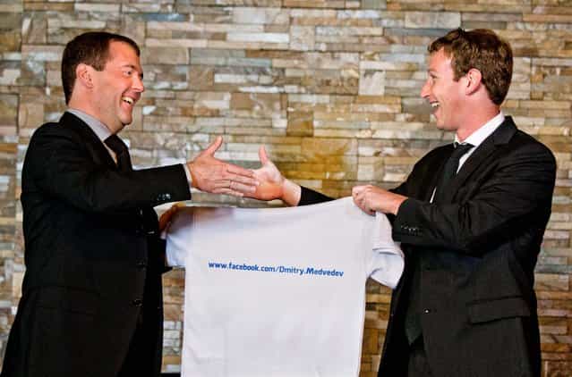 Russian Prime Minister Dmitry Medvedev shakes hands with Facebook CEO Mark Zuckerberg at the Gorki residence outside Moscow, Russia, on Oktober 1, 2012. Zuckerberg presented Medvedev with a T-shirt bearing his Facebook address. (Photo by Alexander Zemlianichenko/Associated Press)