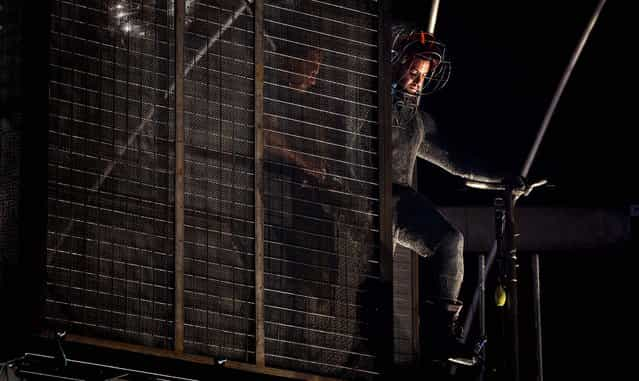 Magician David Blaine steps onto the main platform inside an electrified apparatus surrounded by Tesla coils before his 72-hour [Electrified: 1 Million Volts Always On] stunt on Pier 54 in New York City on October 5, 2012. (Photo by John Minchillo/Associated Press)