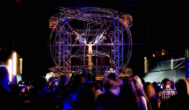The illusionist will spend three days and nights standing in the middle of the million volts of electric currents streamed by tesla coils on October 5, 2012. The 39-year-old Blaine is wearing a chainmail bodysuit as a barrier between himself and the electric currents. (Photo by John Minchillo/Associated Press)