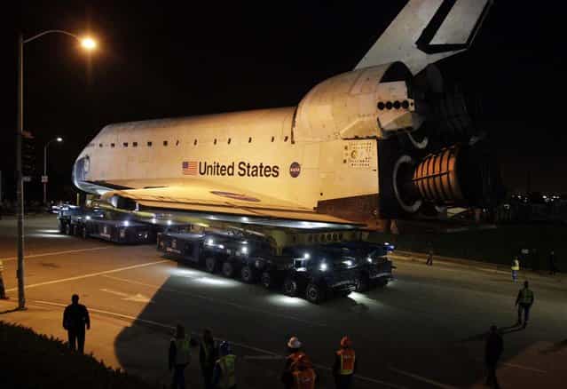 The space shuttle Endeavour leaves Los Angeles International Airport onto the streets of the Westchester neighborhood in the early hours of in Los Angeles, California. The space shuttle will make a two-day trek across Los Angeles and Inglewood to the California Science Center, where it will be on permanent display. (Photo by Lawrence K. Ho)
