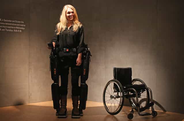 Sophie Morgan walks with the aid of "Rex", a Robotic Exoskeleton at the Welcome Trust on September 19, 2012 in London, England. The system allows wheelchair users including fully paralyzed people, to stand upright and walk independently. Sophie was paralyzed from the breast bone down in 2003 following a car accident. (Photo by Dan Kitwood)
