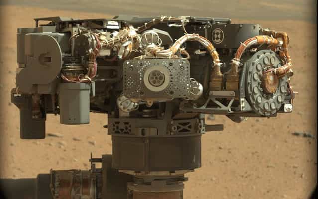 On Mars, NASA's Curiosity rover images itself – this image shows the rover's Alpha Particle X-Ray Spectrometer (APXS), with the Martian landscape in the background. The image was taken by Curiosity's Mast Camera on the 32nd Martian day, or sol, of operations on the surface (September 7, 2012). APXS can be seen in the middle of the picture. This image let researchers know that the APXS instrument had not become caked with dust during Curiosity's dusty landing. Scientists enhanced the color in this version to show the Martian scene as it would appear under the lighting conditions we have on Earth, which helps in analyzing the terrain. (Photo by NASA/JPL-Caltech/MSSS)