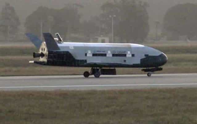 This image from video made available by the Vandenberg Air Force Base shows the X-37B unmanned spacecraft landing at Vandenberg Air Force Base, on June 16, 2012. The spacecraft, which was launched from Cape Canaveral Air Force Station in Florida in March 2011, conducted in-orbit experiments during a 15-month clandestine mission, officials said. It was the second such autonomous landing at the base. (Photo by AP Photo/Vandenberg Air Force Base)
