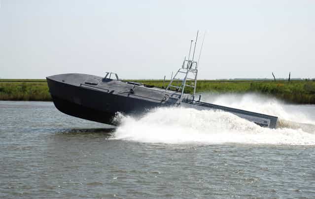 Defense contractor Textron Inc. demonstrates what it calls its Common Unmanned Surface Vessel (CUSV) technology at the company's New Orleans shipyard, on April 12, 2012. Technology that sent unmanned aircraft over warzones in Iraq and Afghanistan soon could be steering unstaffed boats for such dangerous tasks as minesweeping, submarine detection, intelligence gathering and approaching hostile vessels. (Photo by AP Photo/Textron, Inc.)