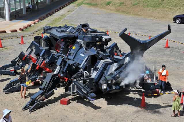 A large beetle-shaped robot [Kabutom RX-03], produced by a Japanese engineer Hitoshi Takahashi is displayed before public at the Tsukuba Festival at Tsukuba city, Tokyo, on August 26, 2012. The Kabutom, 11-meters in length and weighing 17-tons, can walk with its six legs, powered by diesel engines and can blow smoke from its nose. (Photo by Yoshikazu Tsuno/AFP Photo)