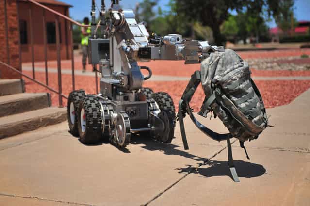 The Andros F6A robot, controlled by U.S. Air Force Explosive Ordinance Disposal team members, carries a backpack containing an improvised explosive device during a hostile threat exercise at Cannon Air Force Base, N.M., June 20, 2012. Air Commandos responded quickly to maintain control of the situation. (U.S. Air Force photo by Airman 1st Class Eboni Reece)