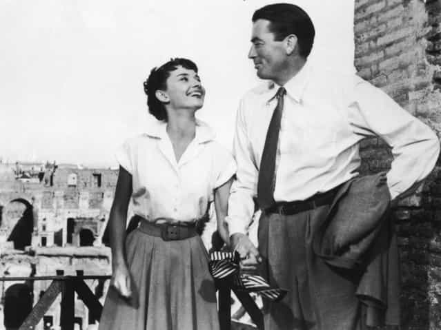 Belgian-born actor Audrey Hepburn (1929–1993) holds the hand of American actor Gregory Peck in a still from the film [Roman Holiday], directed by William Wyler, 1953. Actor Gregory Peck died June 12, 2003 at age 87 of natural causes in his Los Angeles, California home. (Photo by Paramount Pictures)