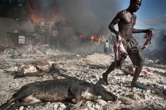 Haiti, Petion-Ville. Fire at a pig seller’s in Parc Charbon slums in November 2003. (Photo by Jean-Claude Coutausse)