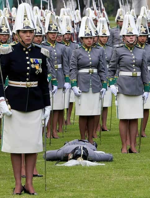 A female cadet, member of the General Francisco de Paula Santander Cadet's School, faints during the Colombian Police 121th Anniversary ceremony in Bogota, Colombia, on 2 November 2012. Colombian President, Juan Manuel Santos, and his counterparts from Costa Rica, Laura Chinchilla and Honduras, Porfirio Lobo attended the event. (Photo by Leonardo Munoz/EPA)