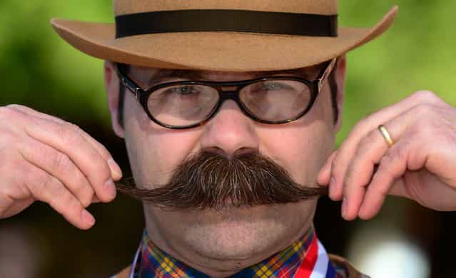 Adam Orcutt from Michigan City, Indiana, poses after winning first place in the Natural Moustache category at the third annual National Beard and Moustache Championships in Las Vegas, Nevada on November 11, 2012. (Photo by Frederic J. Brown/AFP Photo)