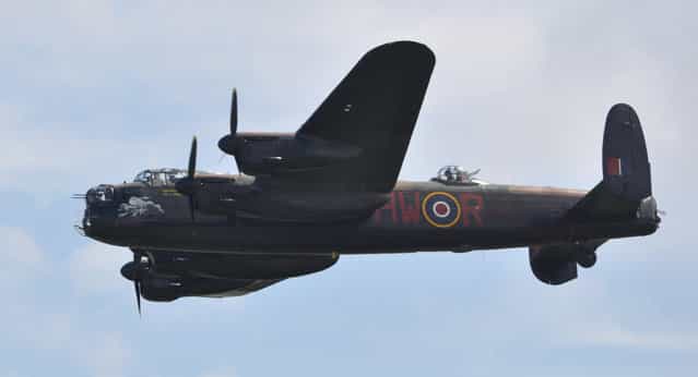 Avro Lancaster of the Battle of Britain Memorial Flight – Flying Legends Airshow Duxford 2012. The Avro Lancaster is the most famous and successful RAF heavy bomber of World War Two. It is a legend that lives on today and the contribution made by the aircraft and its crews to the freedom of our nation will, hopefully, never be forgotten. The prototype Lancaster took to the air for its first flight from Woodford, Manchester, on 9th January 1941; the first production Lancaster flew later that year on 31st October. The first RAF unit to receive the new aircraft for operations (on Christmas Eve 1941) was No 44 Squadron at Waddington, quickly followed by 97 Squadron at Woodhall Spa. The performance of the Lancaster was simply outstanding. It could carry a maximum bomb load of 22,000 lb, its maximum level speed with a full load at 15,000 feet was 275 mph and it could cruise routinely at altitudes above 20,000ft at a range speed of 200 mph. With a full bomb load the aircraft had a range in excess of 1,500 miles. The Lancaster’s performance, its ruggedness, reliability and to many its sheer charisma, endeared it to its crews who were proud to fly this famous thoroughbred. (Rob Lovesey)