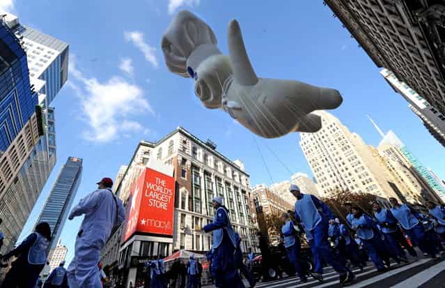 The Pillsbury Doughboy balloon makes his way through Herald Square during the 86th annual Macy's Thanksgiving Day Parade. (Photo by Louis Lanzano/Associated Press)