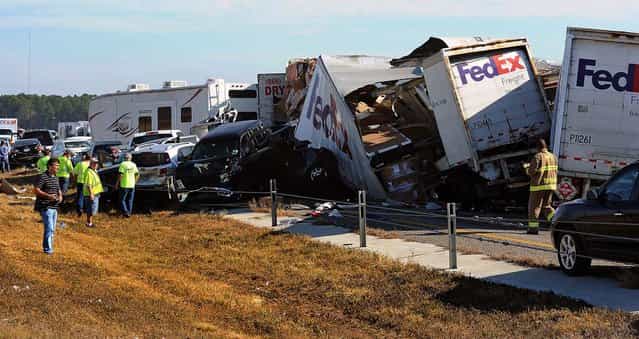Cars and trucks are piled on Interstate 10 in Southeast Texas, November 22, 2012. The Texas Department of Public Safety says at least 35 people have been injured in a more than 50-vehicle pileup. (Photo by Guiseppe Barranco/The Beaumont Enterprise)