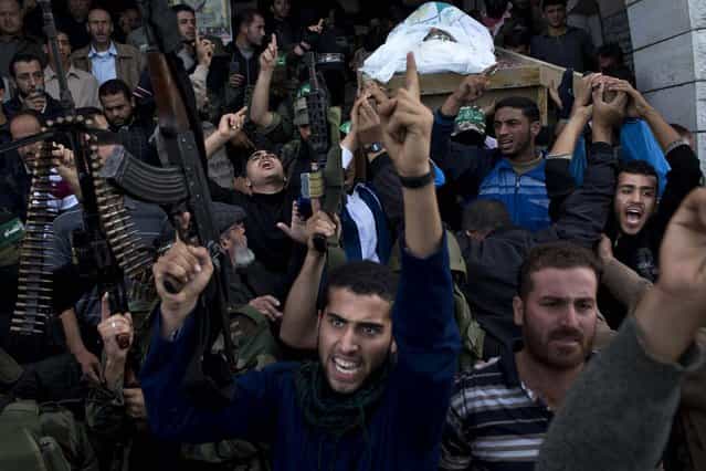 Hamas militants of the Izzedine al-Qassam Brigades attend the funeral of Hamas member Joudeh Shamallah in Gaza City, November 24, 2012. According to family members, Shamallah was badly injured during the recent Israeli-Hamas fight and died from wounds Saturday. (Photo by Bernat Armangue/Associated Press)